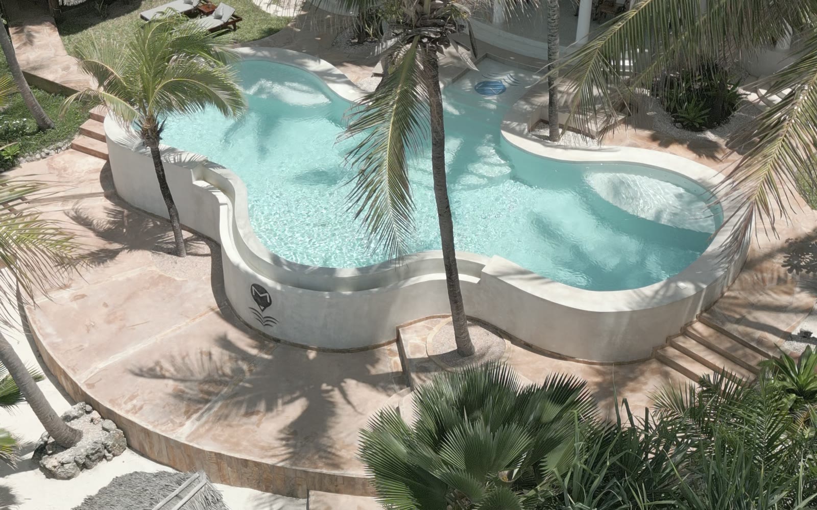 Aerial view of the pool at Boutique Hotel Matlai between palm trees